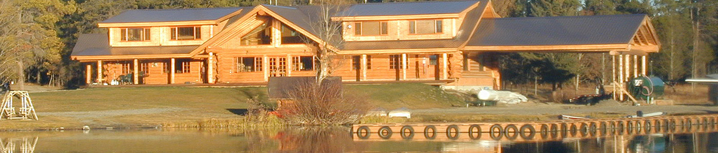 Header Photo of the lodge, several cabins and the lawn