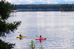 A yellow and a red kayak paddled across the water.