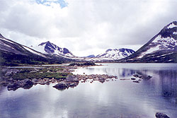 Photo property of Mary Kirner. Volcanic cones reflected in the clear water of an alpine lake. 