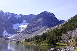 Photo property of Miriam Schilling. A rugged knob of rock overlooks a high, clear mountain lake.