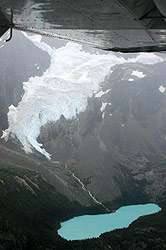 Photo property of Debra Austin. A high cliff glacier feeds down into this green blue lake.